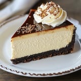 A slice of chocolate cake with whipped cream on a plate.