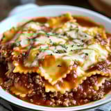 A bowl of pasta with meat sauce.